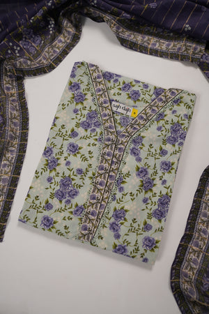 A folded light green kurta with a purple floral print and embroidered neckline, displayed on a white surface with a matching patterned scarf draped around it.